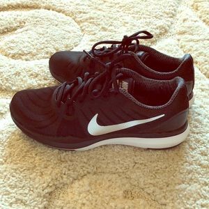 Black Nike trainer shoes.